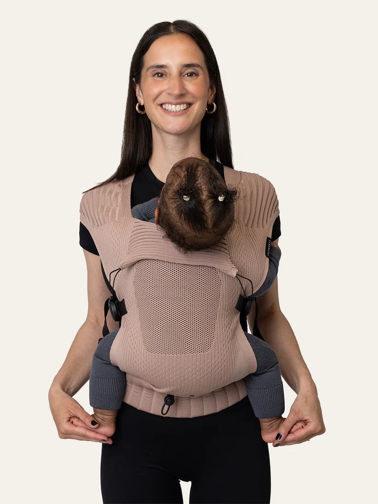 Parent wearing baby in Flybaby front carry position